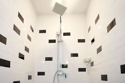 A view of the inside of the black and shower stall
