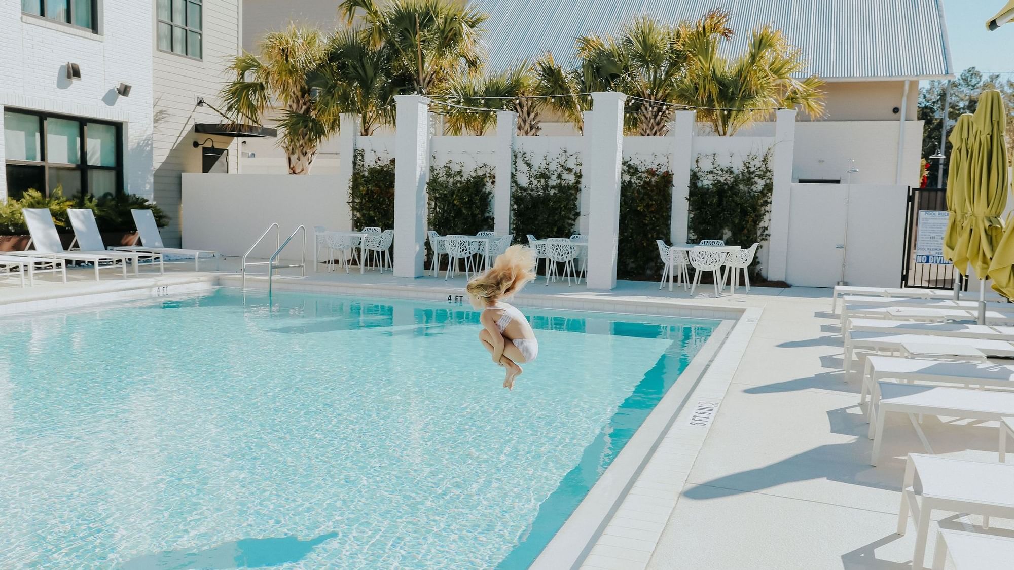 Girl Jumping into Pool at The Lodge 30A
