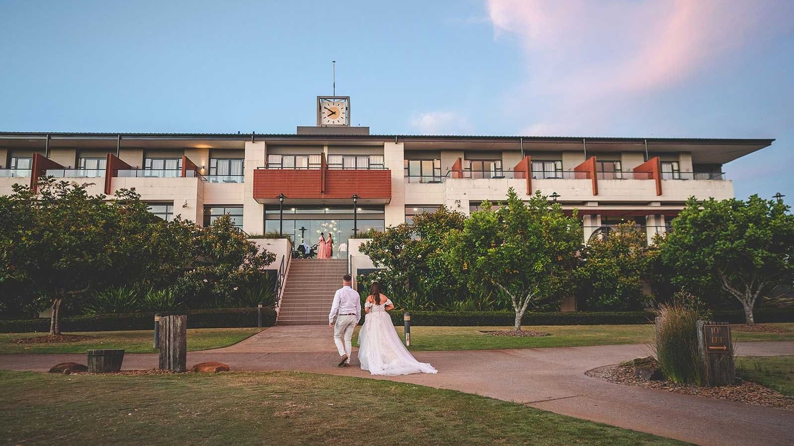 A couple walking into their reception at Mercure Kooindah Waters
