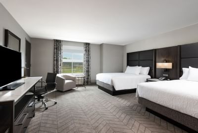 two beds in hotel room with window