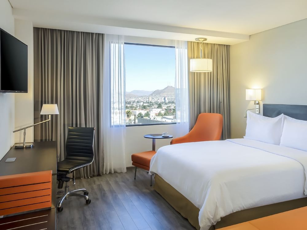 King bed with working desk in Superior Room at Fiesta Inn
