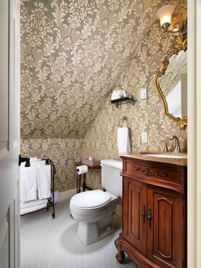 Bathroom interior with vintage wallpaper & vanity in Emily Carr Suite at Pendray Inn & Tea House
