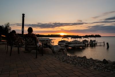 Two women enjoying sunset near boatyard at Chase on The Lake