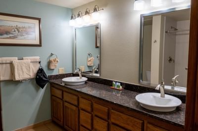Bathroom vanity with an oval sink and granite countertops in The Cottonwoods at The Ranch at UCross
