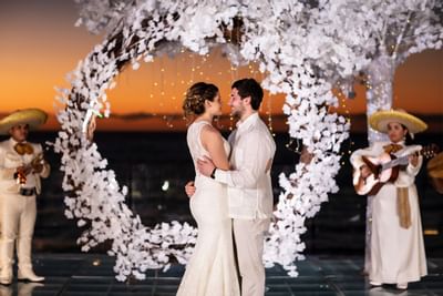 Wedded couple enjoying a romantic evening at Playa Los Arcos