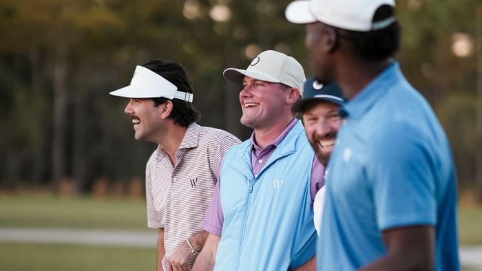 Four men in sports attire, possibly playing golf, celebrating for Father's Day.