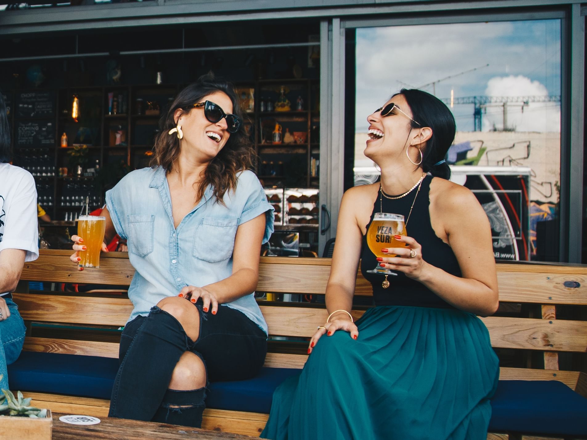 Ladies laughing and drinking beer at The Rockaway Hotel