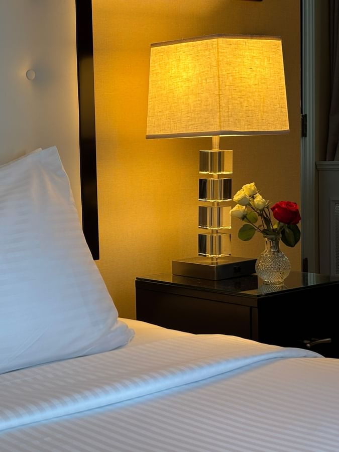 Close-up of bed with table lamp on side tables in Executive King at Warwick Allerton Chicago