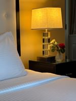 Bed with table lamp on side table in Executive King at Warwick Allerton Chicago