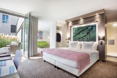 Junior Suite with open windows overlooking the patio lounge at Starling Hotel Lausanne accommodation