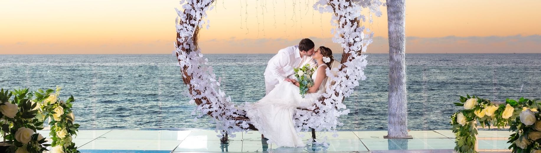 Couple enjoying their wedding day at Playa Los Arcos
