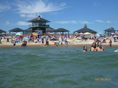 People enjoying on a Misquamicut State Beach with pavilion near Breezeway Boutique Hotel