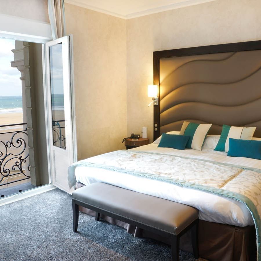 Double bed in Croisiere Salon Room with outdoor sea view at Le Grand Hôtel des Thermes
