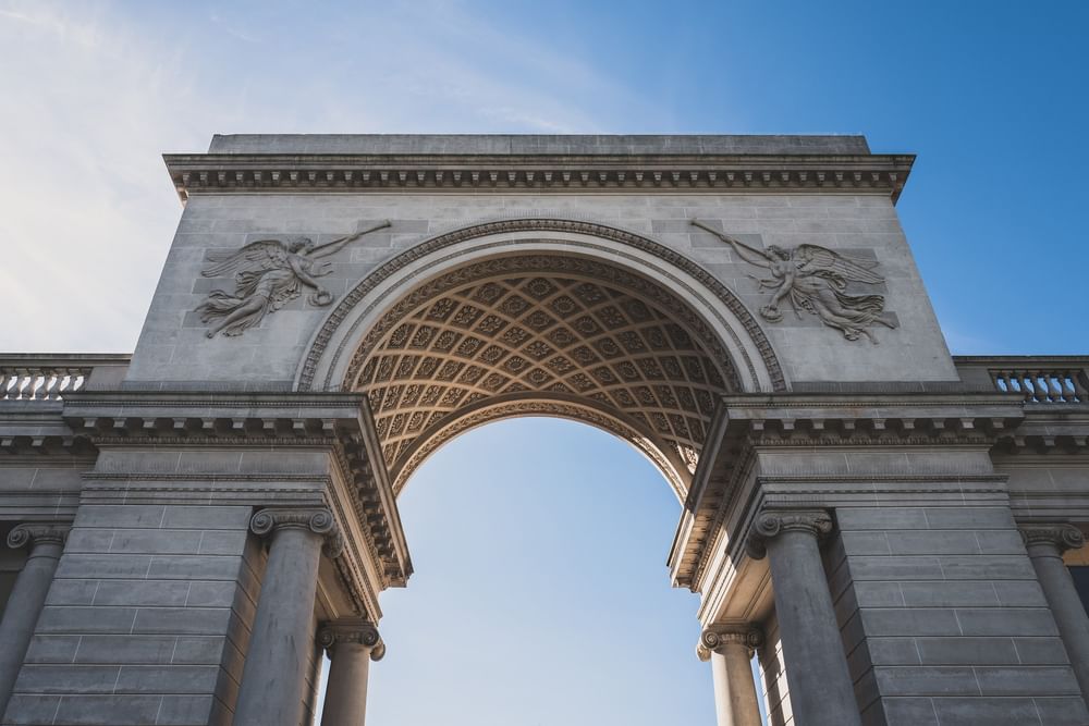 Lincoln Park with angel carvings under a clear sky near architectural columns near Warwick San Francisco