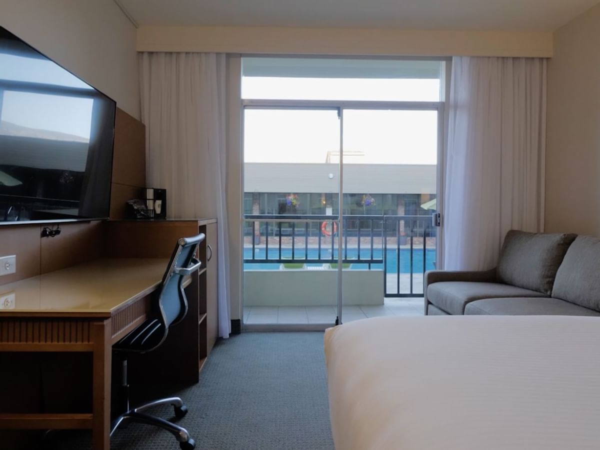 Guest room with queen bed, desk, sofa bed and television