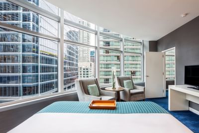 Cityscape from a bed in One Bedroom Suite at Kinzie Hotel