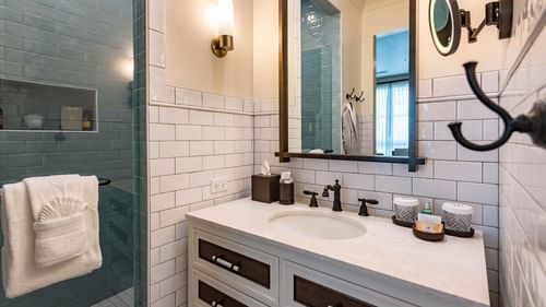 Bathroom vanity & shower area in Junior Golf Suite at Camp Creek Inn