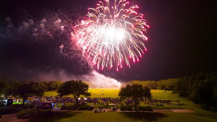 Fireworks display over the Camp Creek driving range with a crowd gathered for Fourth of July celebration.