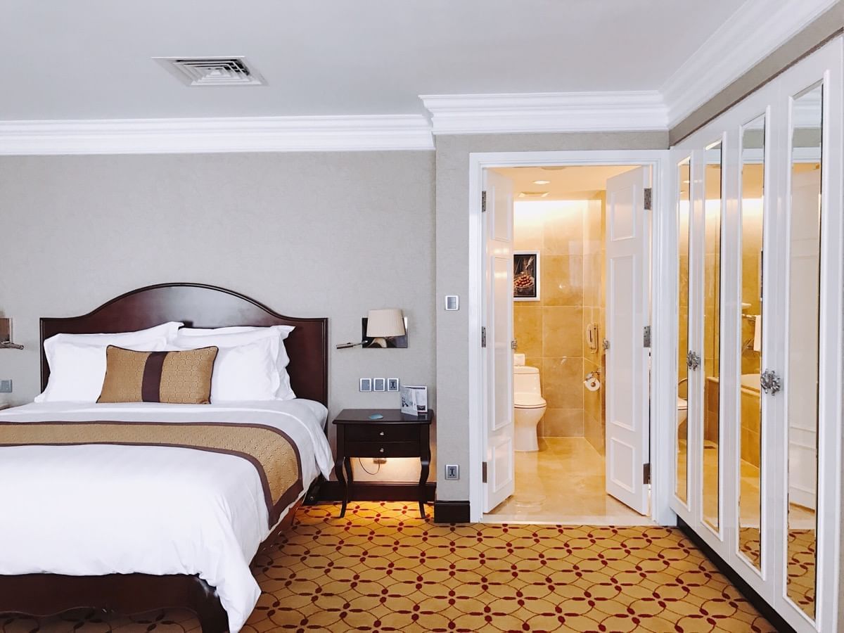 Family Deluxe Room with a king size bed & bathroom at Eastin Grand Hotel Saigon