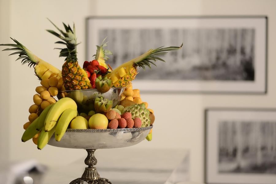 Tropical fruit bowl with pineapples by bananas under a soft-focus background at Warwick Stone 55 - Beirut