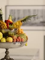 Silver fruit bowl featuring pineapples by bananas on a counter in Executive Suite at Warwick Stone 55 - Beirut