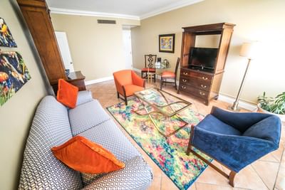 Spacious living area with cozy couches in a Suite at Courtleigh Hotel & Suites