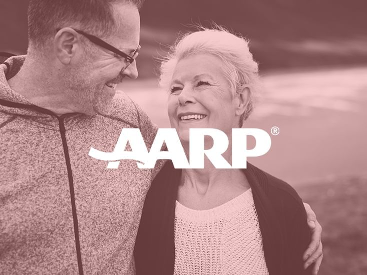 An elder couple in AARP discount banner at South Beach Hotel