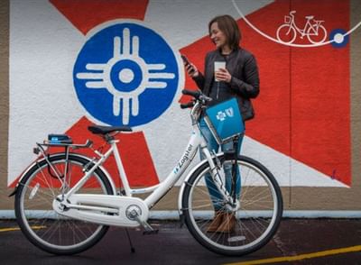 Women standing next to a bike near Hotel at Old Town Wichita