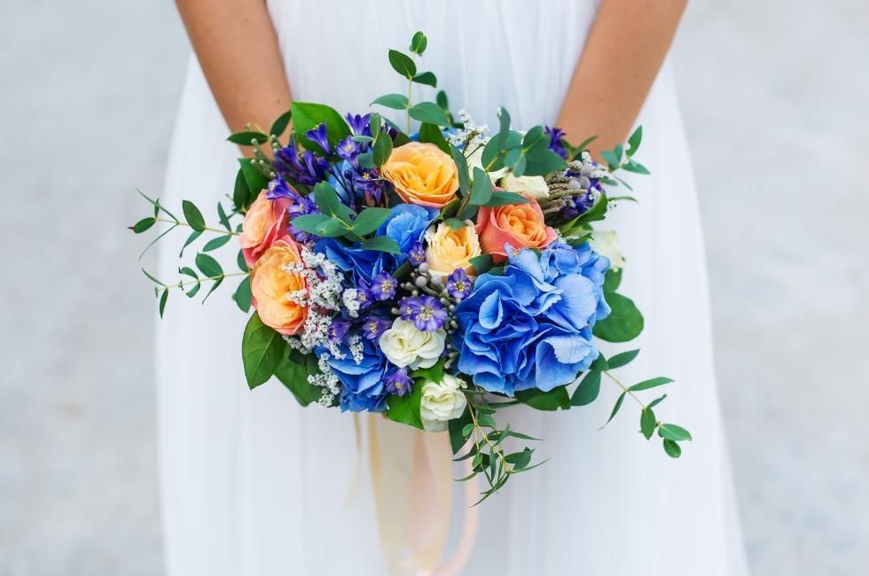 blue bouquet with bride holding it