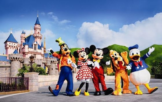 A group in cartoon costumes at Disneyland near Amara Hotel