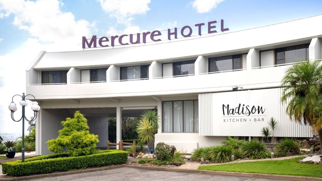 White Mercure hotel building with Madison Kitchen and Bar sign at Mercure Charlestown.