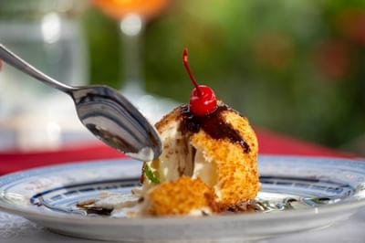 Spoon scooping a bite of ice cream topped with cherry at Naviti Resort Fiji Coral Coast