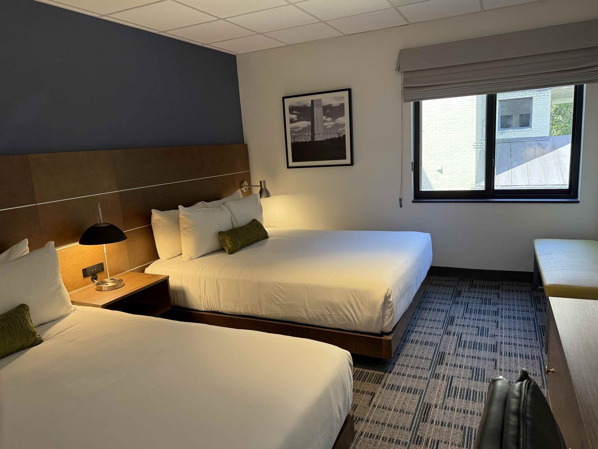 Deluxe Double Rooms featuring two queen size beds, a window and a mirror at Bolger Center