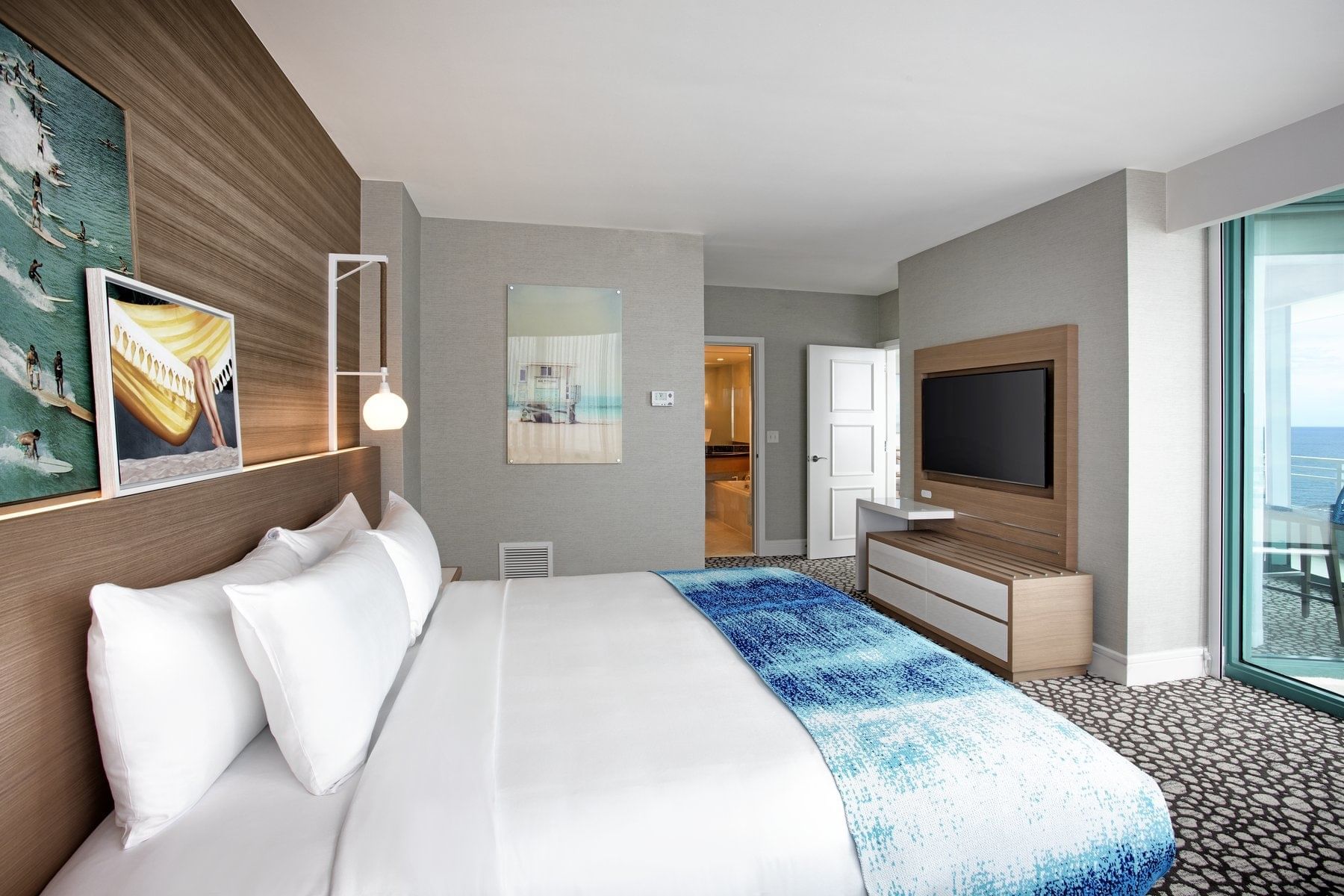 Kingbed & tv in the corner suite bedroom at Diplomat Resort 