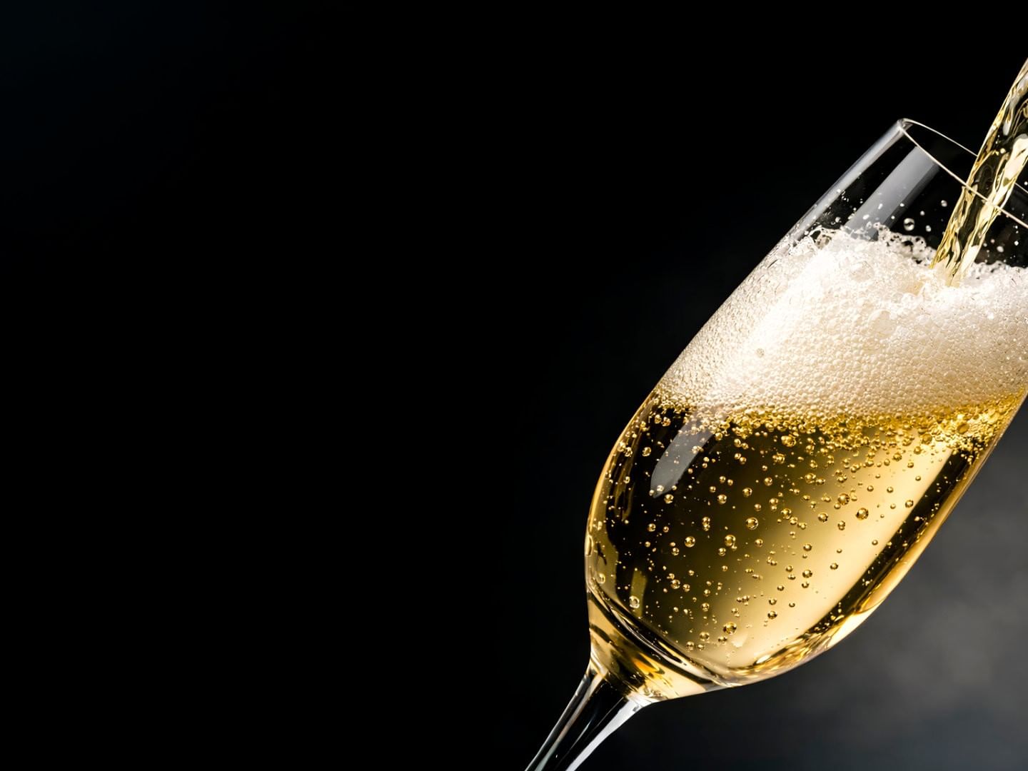 Bubbling flute of luxury champagne being poured against a sleek black background at Camino Real Polanco Mexico