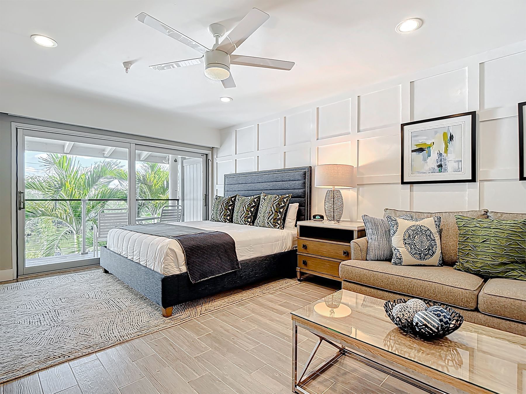 Efficiency Park View room with bed, sofa, and balcony at Cove Inn at Naples Bay.