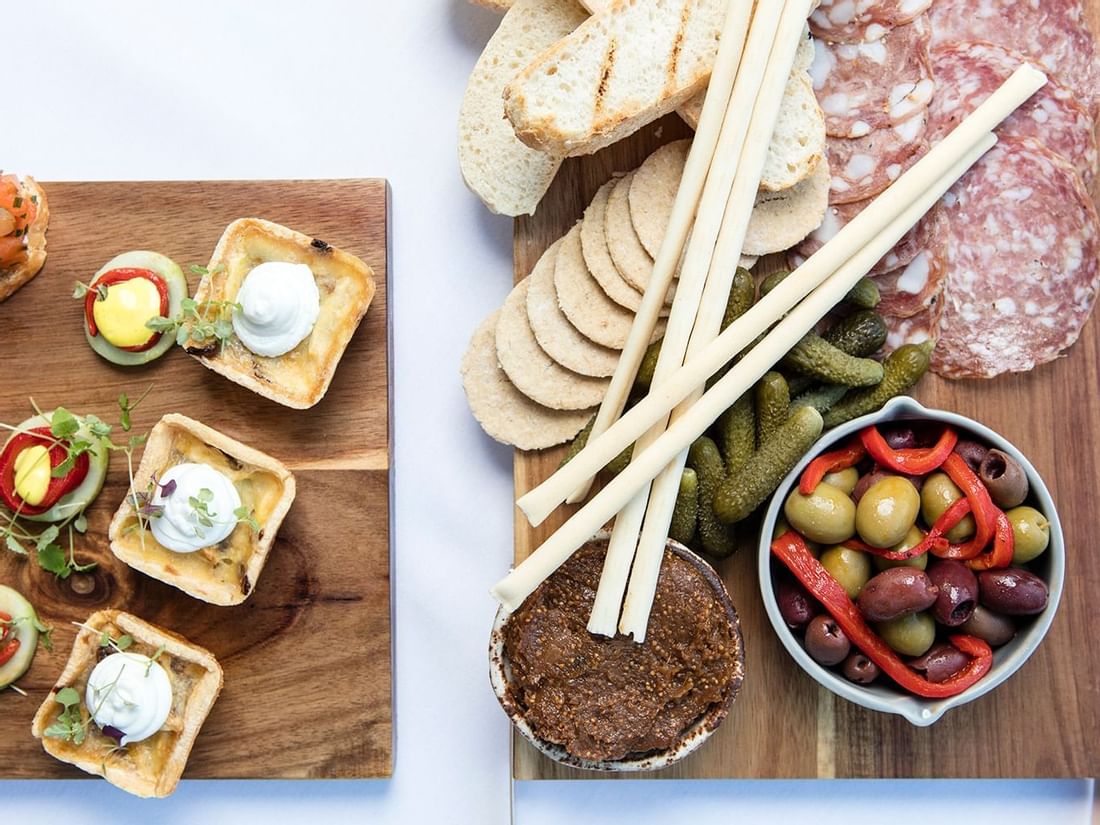 Overhead view of a canape board with meats, olives, crackers, and pate served in The Croft House at The Sebel Brisbane