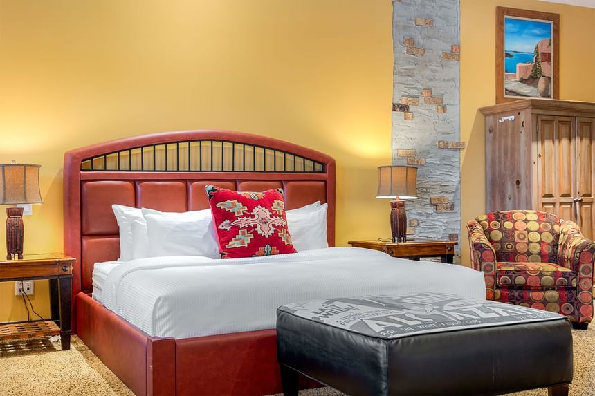 King-size bed, lamps & comfy chairs in King Premiere Sante Fe at Retro Suites Hotel