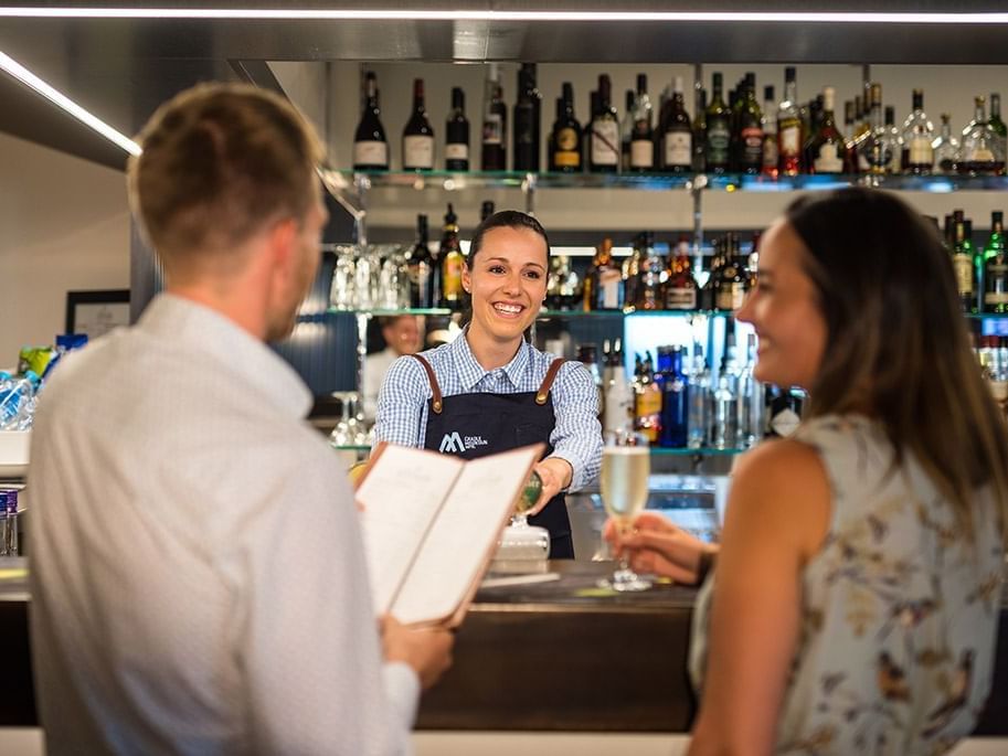 Couple at the cashier in Altitude Bar in Cradle Mountain Hotel