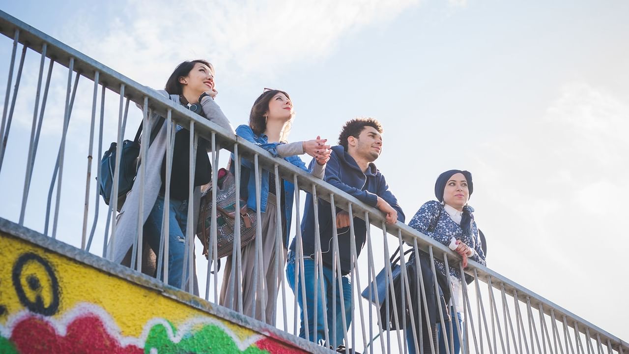 group of young people resting on a handrail