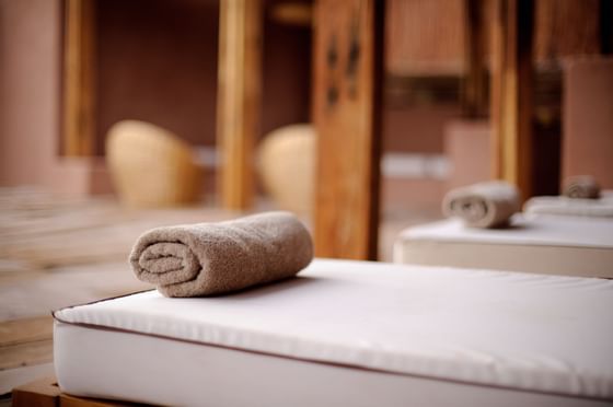 relaxing spa beds and towel rolls at NOI Casa Atacama Hotel