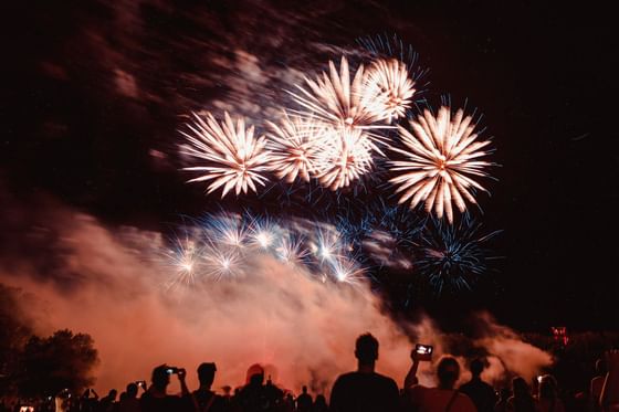 People enjoying fireworks at night near Pelangi Beach Resort