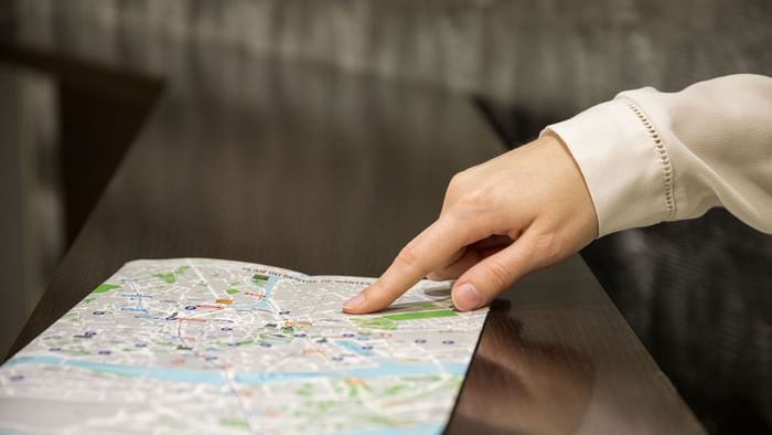 A lady observing a map in Hotel du Grand Monarque
