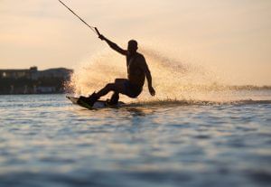 A man wakeboarding at sunset near Rosen Inn Universal