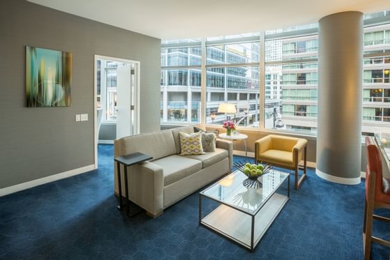 Sofa with a coffee table in One Bedroom Suite at Kinzie Hotel