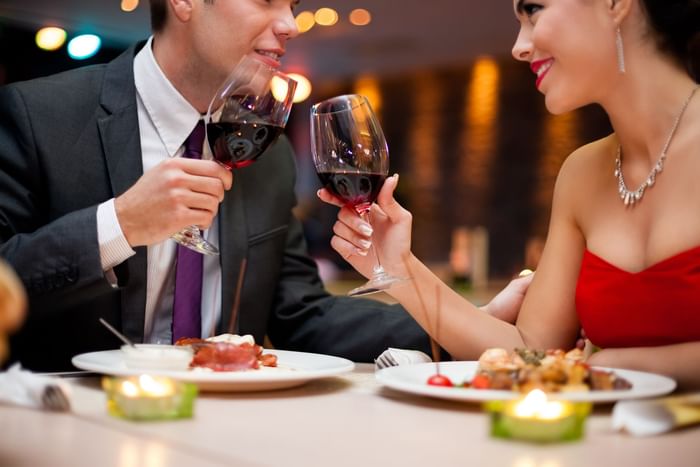 a couple enjoying dinner and wine at Diplomat Prime restaurant at Diplomat Resort