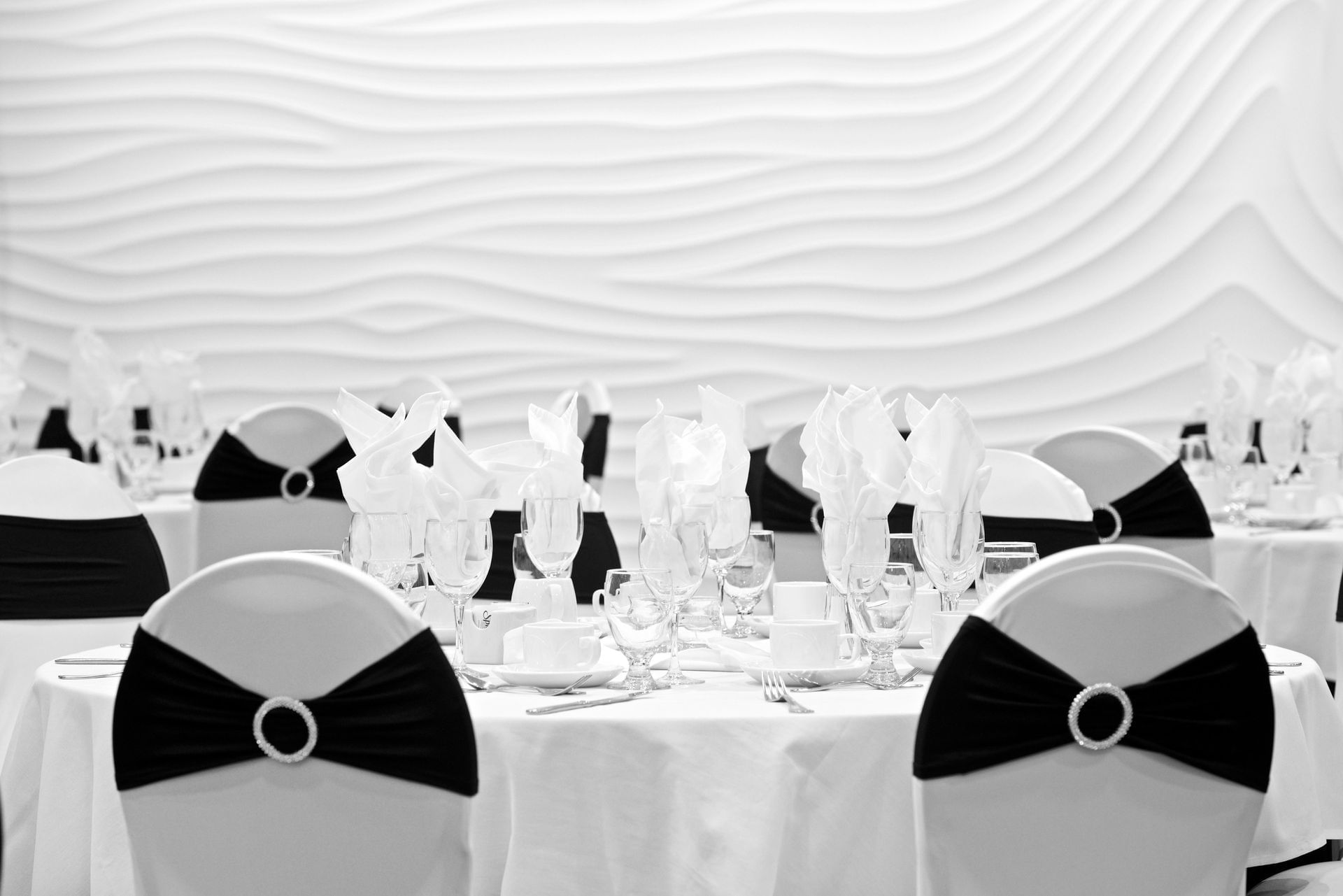 Black and white tables and chairs set up for event