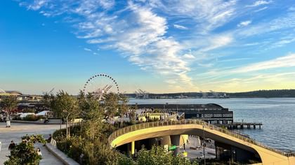 The Great Wheel by the waterfront and city pier under a blue sky near Warwick Seattle