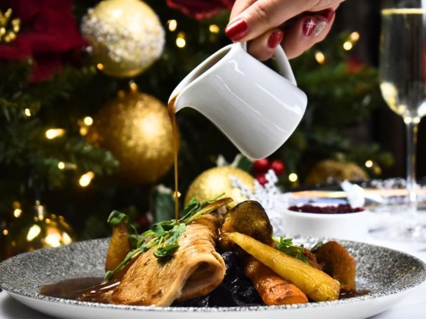 Gravy being poured on festive lunch at Gorse Hill in Surrey