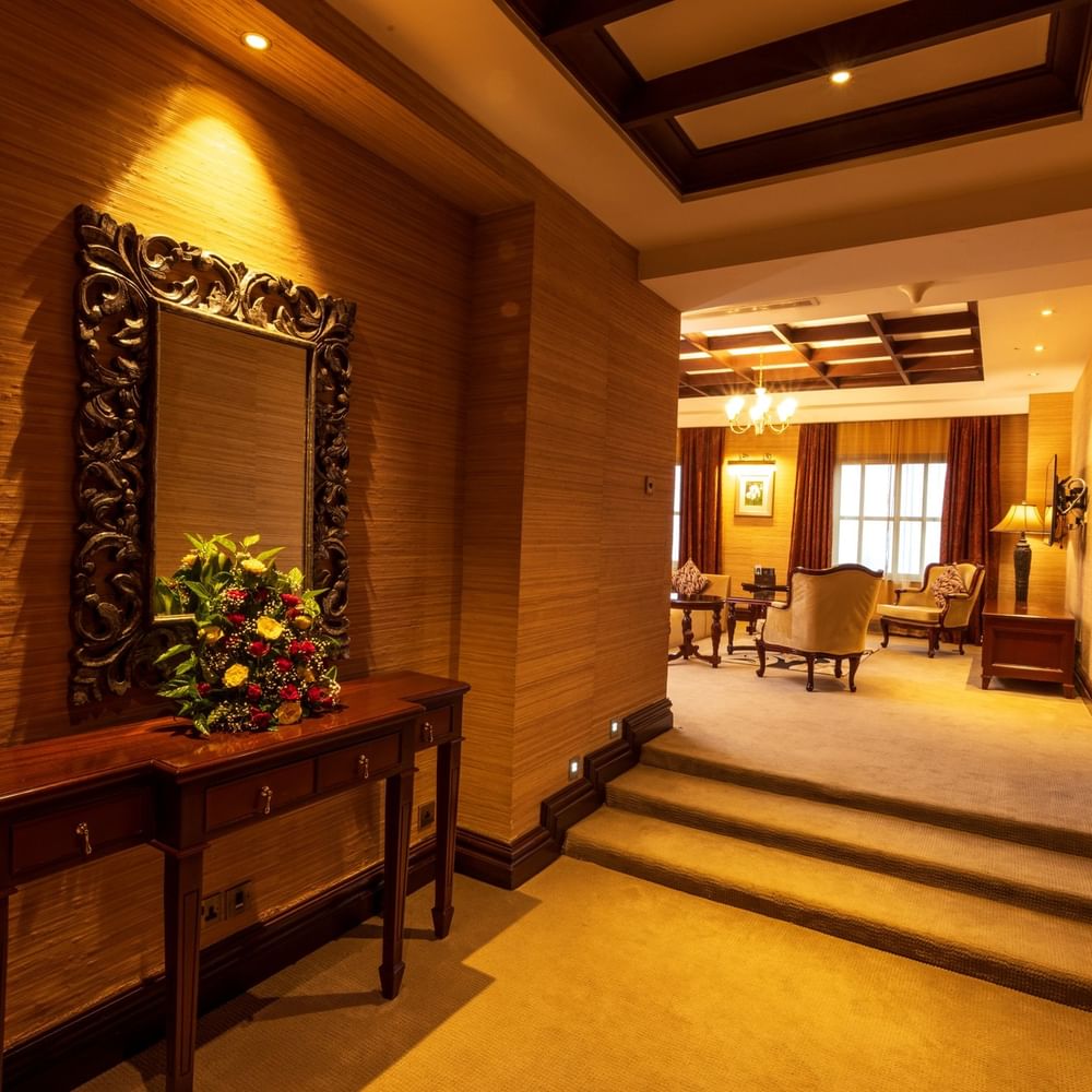 Presidential Suite hallway with floral arrangement and ornate mirror at Lake Victoria Serena Golf Resort & Spa in Kampala.